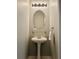 Stylish powder room with pedestal sink, oval mirror, and decorative lighting at 375 Highland Ne Ave # 913, Atlanta, GA 30312