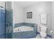 Bathroom with tiled bathtub, shower, toilet, and modern fixtures at 375 Highland Ne Ave # 913, Atlanta, GA 30312