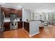 Modern kitchen with stainless steel appliances, rich wood cabinets, and an open layout to the living space at 375 Highland Ne Ave # 913, Atlanta, GA 30312