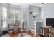 Sunlit living room featuring large windows, hardwood floors, and an adjacent staircase at 375 Highland Ne Ave # 913, Atlanta, GA 30312