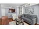 Open-concept living room with hardwood floors, built-in shelving, and seamless flow to the kitchen at 375 Highland Ne Ave # 913, Atlanta, GA 30312