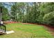 Expansive backyard with lush green grass and mature trees at 4091 Oak Forest Ne Dr, Brookhaven, GA 30319