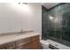 Bathroom with wood vanity, and a shower with emerald green subway tile at 4091 Oak Forest Ne Dr, Brookhaven, GA 30319