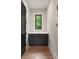 Hall bathroom with white countertops, gray cabinets, and hardwood floors at 4091 Oak Forest Ne Dr, Brookhaven, GA 30319