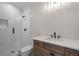 Bathroom featuring white tile shower and wood vanity at 4091 Oak Forest Ne Dr, Brookhaven, GA 30319