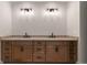 Bathroom with dual sinks, granite countertops, and wood cabinets at 4091 Oak Forest Ne Dr, Brookhaven, GA 30319