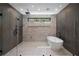 Modern bathroom with large walk-in shower, soaking tub, and elegant tiling at 4091 Oak Forest Ne Dr, Brookhaven, GA 30319