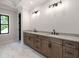 Bright bathroom featuring a double vanity, quartz countertop, and marble tile flooring at 4091 Oak Forest Ne Dr, Brookhaven, GA 30319