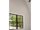 Bedroom showcasing black-framed window with natural light and neighborhood view at 4091 Oak Forest Ne Dr, Brookhaven, GA 30319