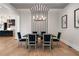 Dining room with modern chandelier, accent wall, and seating for six, adjacent to the kitchen at 4091 Oak Forest Ne Dr, Brookhaven, GA 30319