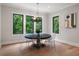 Bright dining area with a round table, seating for six, and backyard views from the energy-efficient windows at 4091 Oak Forest Ne Dr, Brookhaven, GA 30319