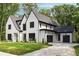 Two story home with gray roof and black trim and a three car garage at 4091 Oak Forest Ne Dr, Brookhaven, GA 30319