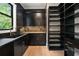 Modern kitchen with black cabinets, granite counters, a pantry, and stainless steel appliances at 4091 Oak Forest Ne Dr, Brookhaven, GA 30319