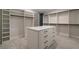 Spacious walk-in closet with custom shelving, drawers and center island at 4091 Oak Forest Ne Dr, Brookhaven, GA 30319