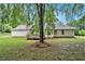 A spacious backyard with a small deck sits behind this home's back exterior at 110 Peach Pointe Dr, Mcdonough, GA 30253