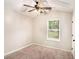 Neutral bedroom features carpet floors, a window, and a ceiling fan at 110 Peach Pointe Dr, Mcdonough, GA 30253