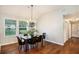 Charming dining area with hardwood floors and natural light from large windows at 110 Peach Pointe Dr, Mcdonough, GA 30253