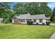 Well-maintained single-story home with lush lawn, attractive stone accents, and manicured shrubs at 110 Peach Pointe Dr, Mcdonough, GA 30253