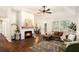 Inviting living room featuring a cozy fireplace, hardwood floors, and ample natural light at 110 Peach Pointe Dr, Mcdonough, GA 30253