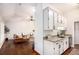 Open-concept living space with wet bar area featuring granite counters and updated cabinets at 110 Peach Pointe Dr, Mcdonough, GA 30253