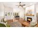 Open-concept living area with fireplace, hardwood floors, and views into the dining area at 110 Peach Pointe Dr, Mcdonough, GA 30253