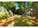 Wooded backyard with a play structure and swingset at 3176 Gablewood Ct, Decatur, GA 30033