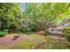 Large, wooded backyard with stone fire pit and multiple deck areas for outdoor enjoyment at 3176 Gablewood Ct, Decatur, GA 30033