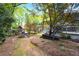 Enjoy the backyard with mature trees and a playset with a slide at 3176 Gablewood Ct, Decatur, GA 30033