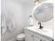 All-white bathroom features a gold-trimmed mirror, modern fixtures, and updated vanity at 3176 Gablewood Ct, Decatur, GA 30033