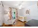 Bedroom with hardwood floors, white rocking chair, and colorful rainbow wall art at 3176 Gablewood Ct, Decatur, GA 30033