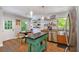 Eat-in kitchen with stainless steel appliances, custom island, wood floors, and backyard access at 3176 Gablewood Ct, Decatur, GA 30033