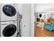 Laundry room featuring stacked washer and dryer, leading to open-concept living space at 3176 Gablewood Ct, Decatur, GA 30033