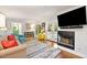 Bright living room featuring hardwood floors, a fireplace, and French doors leading to an outdoor space at 3176 Gablewood Ct, Decatur, GA 30033