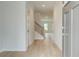 Bright foyer with hardwood floors, staircase, and neutral paint, offering a welcoming entrance to the home at 324 Tulip Dr, Covington, GA 30016