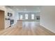 Open-concept kitchen with white cabinets, stainless steel appliances, and seamless flow to living area with fireplace at 324 Tulip Dr, Covington, GA 30016