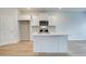 Contemporary kitchen featuring white cabinets, stainless steel appliances, and center island with sink for meal prep at 324 Tulip Dr, Covington, GA 30016