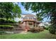 Multi-tiered deck and lush backyard landscaping creates a serene outdoor oasis for relaxation and enjoyment at 3845 Winters Hill Dr, Atlanta, GA 30360