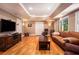 Finished basement featuring a large screen TV, leather furniture, and hardwood floors at 3845 Winters Hill Dr, Atlanta, GA 30360