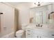 Clean bathroom featuring a large mirror, white tiled walls, and a shower and tub combination at 3845 Winters Hill Dr, Atlanta, GA 30360
