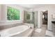 Bathroom features a soaking tub, walk-in shower, natural light, and neutral decor at 3845 Winters Hill Dr, Atlanta, GA 30360