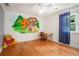 Charming bedroom with a Winnie the Pooh mural, hardwood floors, and natural light at 3845 Winters Hill Dr, Atlanta, GA 30360