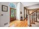 Grand foyer featuring a hardwood floor, staircase, decorative front door with glass detail, and stylish design at 3845 Winters Hill Dr, Atlanta, GA 30360