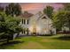 Charming two-story home with a lush green lawn and a beautiful entrance under a colorful sunset sky at 3845 Winters Hill Dr, Atlanta, GA 30360