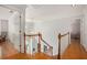 Spacious upstairs hallway with hardwood floors and a view to the stairway at 3845 Winters Hill Dr, Atlanta, GA 30360