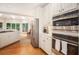 Kitchen showcasing stainless appliances, white cabinets, hardwood floors, and eat-in breakfast nook at 3845 Winters Hill Dr, Atlanta, GA 30360