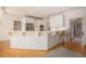 Bright kitchen with stainless appliances, white cabinets, breakfast bar, and hardwood floors at 3845 Winters Hill Dr, Atlanta, GA 30360