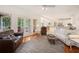 Open living room with backyard access, fireplace, hardwood floors and comfortable seating at 3845 Winters Hill Dr, Atlanta, GA 30360