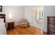 Cozy sitting area in the main bedroom with ensuite bathroom and hardwood floors at 3845 Winters Hill Dr, Atlanta, GA 30360
