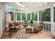 Cozy sunroom features wood floors, ceiling fan, and floor-to-ceiling windows at 3845 Winters Hill Dr, Atlanta, GA 30360