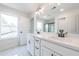 Stylish bathroom featuring a double vanity with modern fixtures, a large window, and a separate glass-enclosed shower at 405 Carrera Ln, Acworth, GA 30102